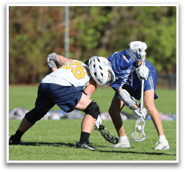 Two people playing a game of lacrosse. Description generated by AI
