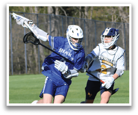 A man in a blue shirt and white pants is running with a lacrosse stick. Description generated by AI