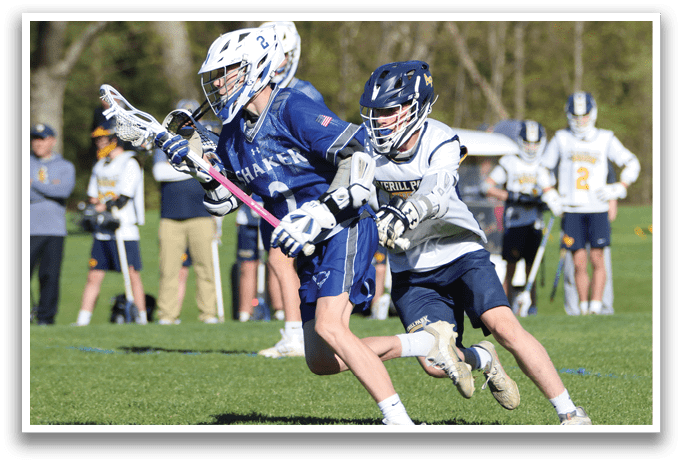 A boy in a blue and white uniform is running with a pink stick. Description generated by AI