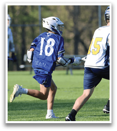 A boy in a blue jersey is running on a field. Description generated by AI