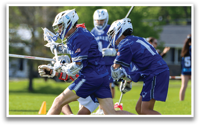 Two men wearing blue uniforms playing lacrosse. Description generated by AI