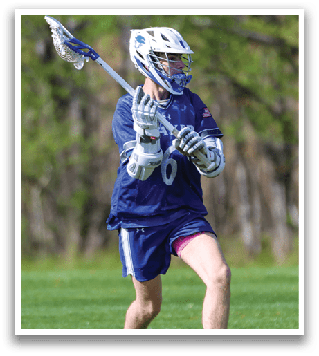 A man wearing a blue and white uniform is holding a lacrosse stick. Description generated by AI