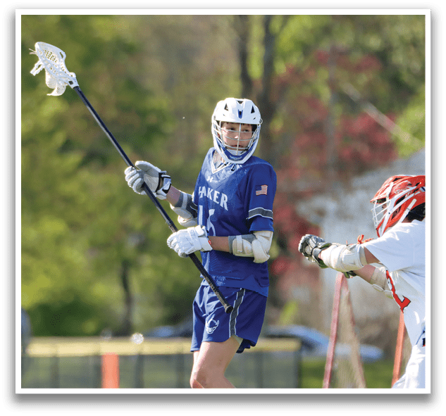 A lacrosse player with the number 11 on his jersey. Description generated by AI
