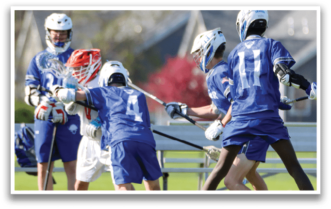 A group of people playing a game of lacrosse. Description generated by AI