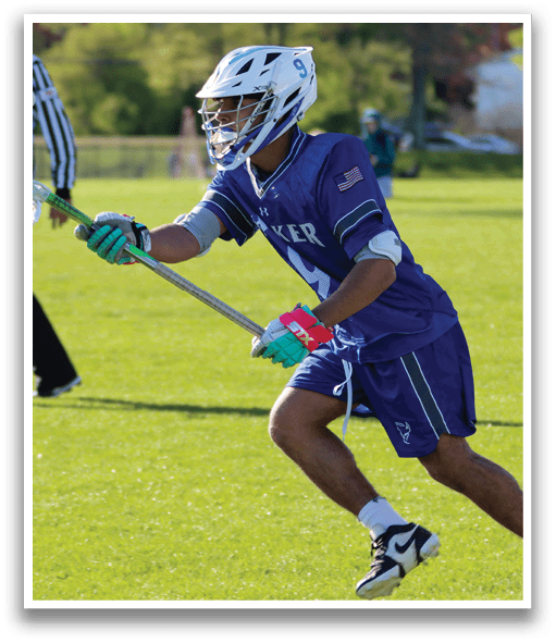 A man wearing a blue and white jersey is playing lacrosse. Description generated by AI