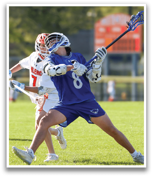 A man wearing a blue and white shirt and white shorts is holding a blue and white lacrosse stick. Description generated by AI