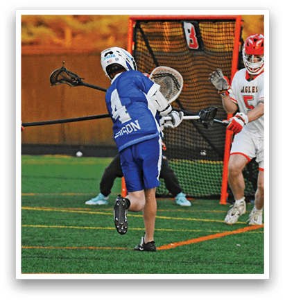 A group of people playing a game of lacrosse. Description generated by AI