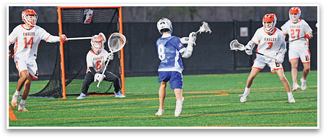 A group of people playing lacrosse on a field. Description generated by AI