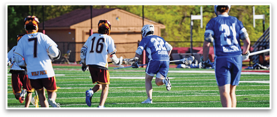 A group of people playing a game of lacrosse. Description generated by AI