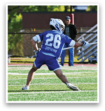 A man in a blue shirt and white shorts is running on a field. Description generated by AI