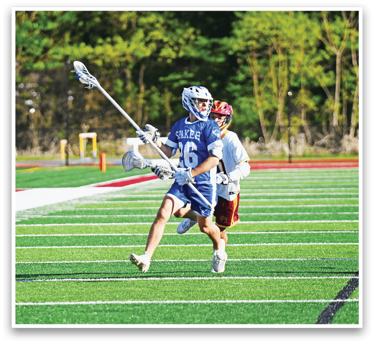 A man wearing a blue and white uniform is running on a field. Description generated by AI
