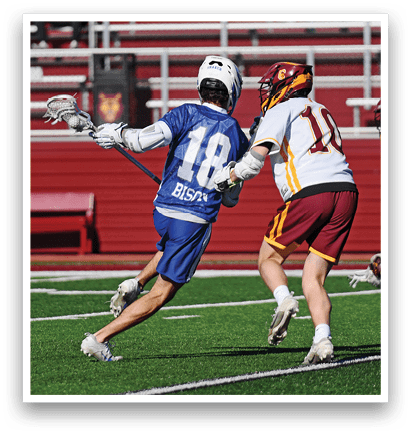 A man in a blue shirt and white shorts is running with a lacrosse stick. Description generated by AI