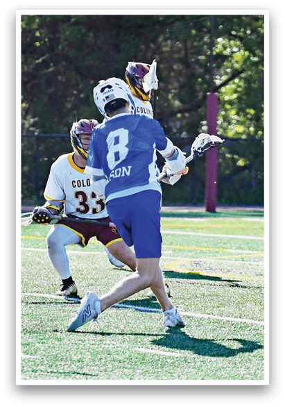 A group of people playing a game of lacrosse. Description generated by AI