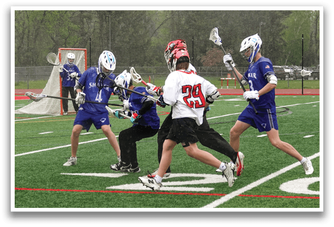 A group of young men playing lacrosse on a field. Description generated by AI