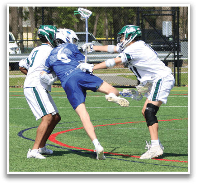 A group of men playing lacrosse on a field. Description generated by AI