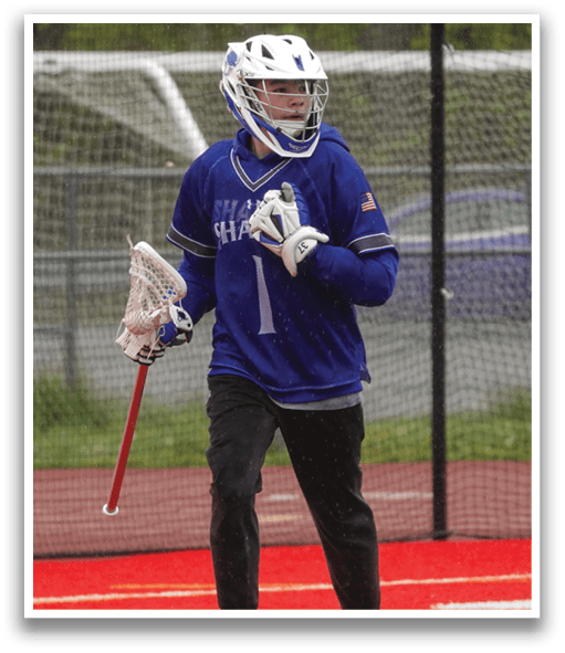 A person wearing a blue and white jersey and holding a red and white stick. Description generated by AI