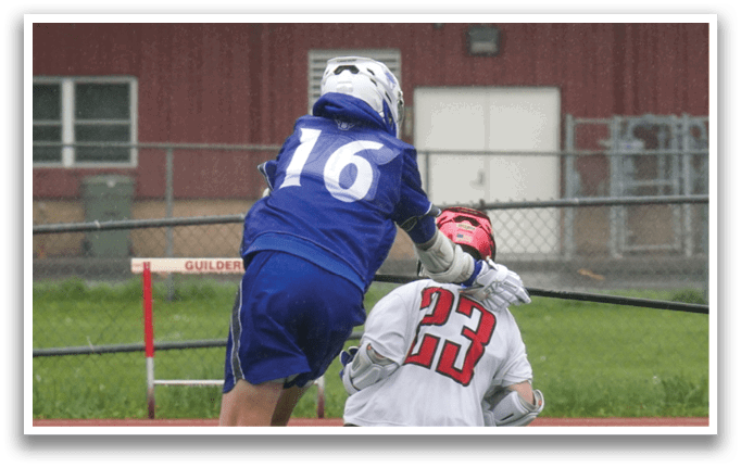 A man in a blue and white uniform is trying to get past a man in a white uniform. Description generated by AI