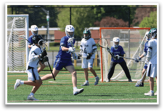 A group of people playing a game of lacrosse. Description generated by AI