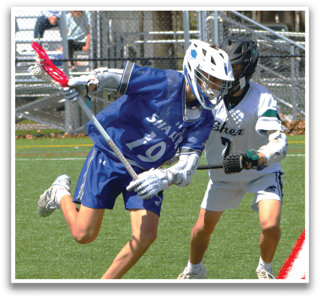 A boy in a blue jersey is running with a stick. Description generated by AI