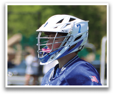 A young man wearing a blue and white jersey with the number 14 on it. Description generated by AI