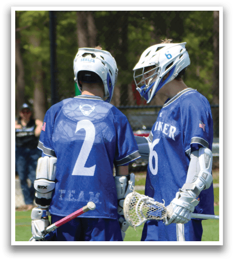 Two lacrosse players wearing blue jerseys with the number 2 and 6 on them. Description generated by AI