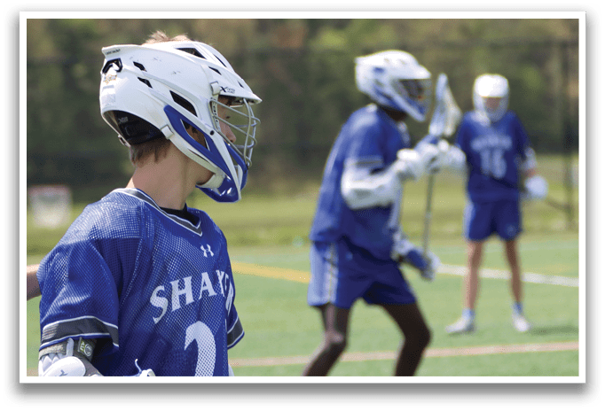 A boy wearing a blue and white jersey with the number 2 on it. Description generated by AI