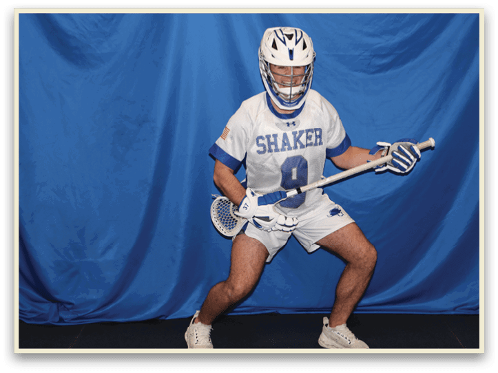 A man wearing a white and blue uniform is holding a lacrosse stick. AI generated content