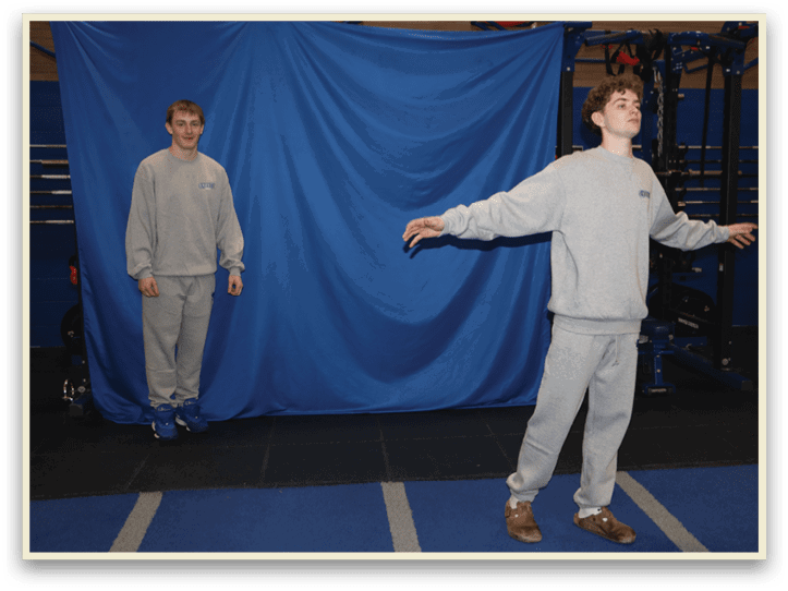 Two men standing in a gym, one with his arms outstretched and the other with his arms at his sides. AI generated content