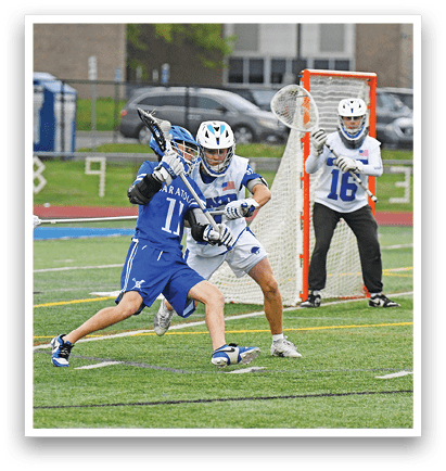 A man in a blue and white uniform is playing lacrosse. Description generated by AI