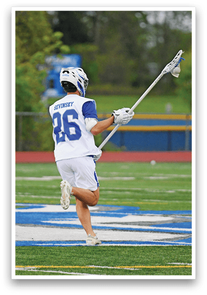 A man wearing a white and blue jersey with the number 26 on it. Description generated by AI