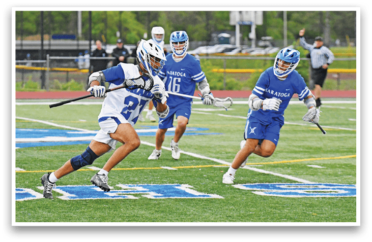 A group of people playing a game of lacrosse. Description generated by AI
