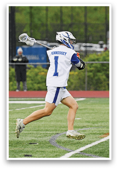 A man wearing a white and blue jersey is running on a field. Description generated by AI