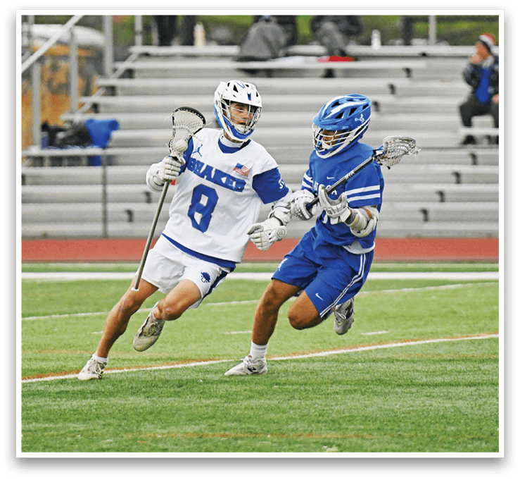 Two lacrosse players running on a field. Description generated by AI