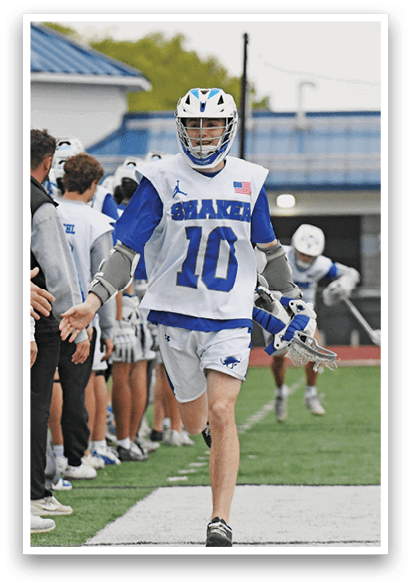 A man wearing a blue and white jersey with the number 10 on it. Description generated by AI