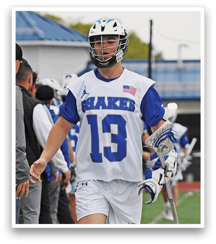A man wearing a white and blue shirt with the number 13 on it. Description generated by AI