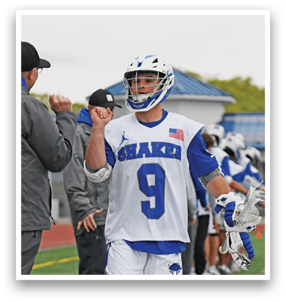 A man wearing a white and blue jersey with the number 9 on it. Description generated by AI