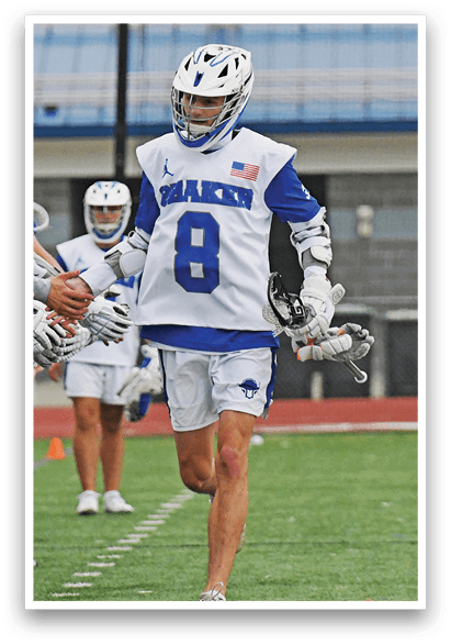 A man wearing a blue and white uniform with the number 8 on the back. Description generated by AI