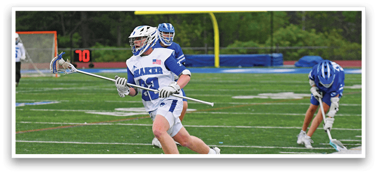 A man wearing a white and blue uniform is running with a lacrosse stick. Description generated by AI