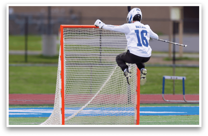 A person wearing a white and blue shirt and black pants is jumping in the air to hit a ball. Description generated by AI