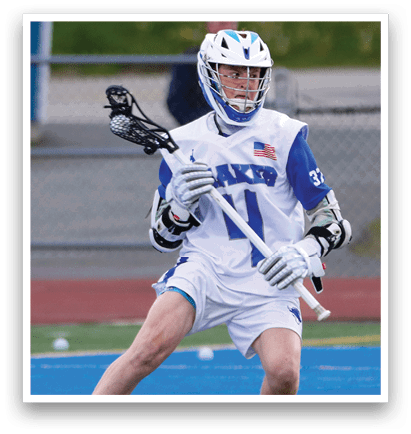 A boy wearing a white and blue jersey with the number 1 on it. Description generated by AI