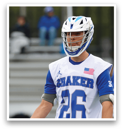 A man holding a lacrosse stick. Description generated by AI