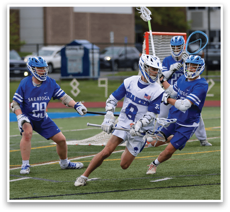 A group of lacrosse players on a field. Description generated by AI