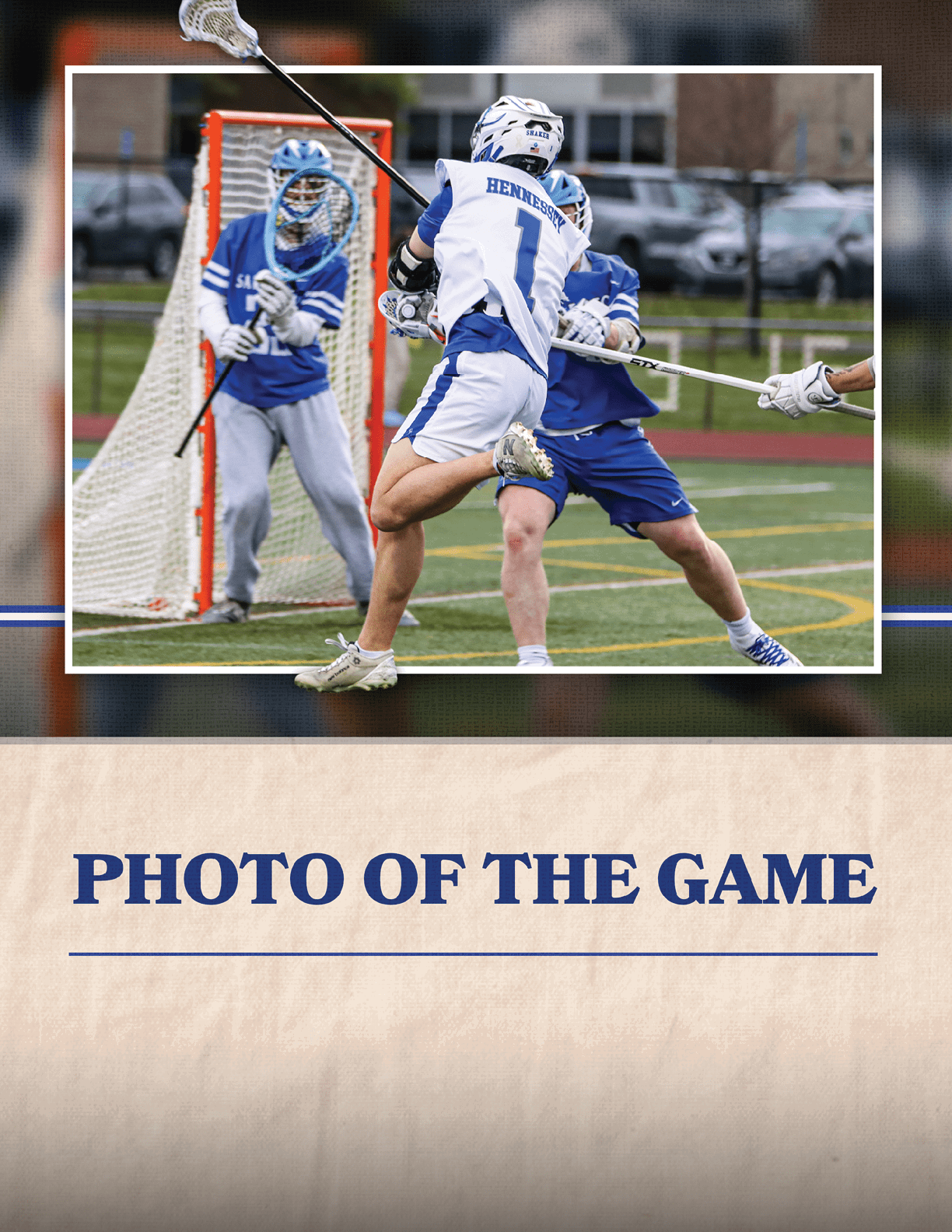 A man wearing a blue shirt and white shorts is playing lacrosse. Description generated by AI