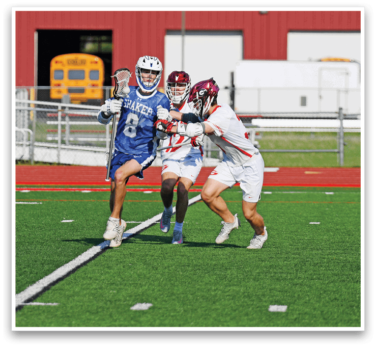 A boy in a blue and white uniform is running on a field. Description generated by AI