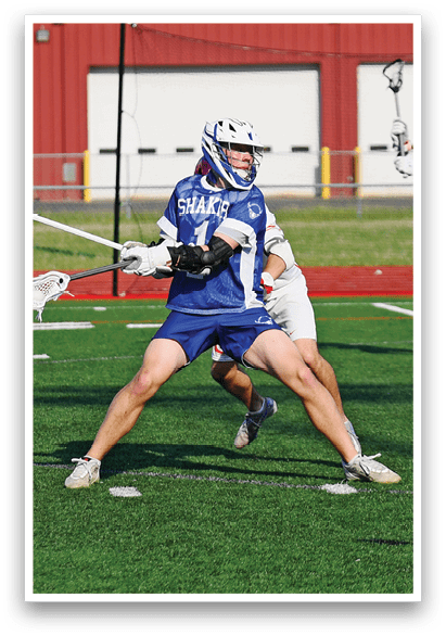 A group of people playing a game of lacrosse. Description generated by AI