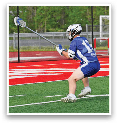 A man in a white shirt and red helmet is holding a lacrosse stick. Description generated by AI