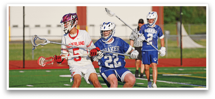 Two lacrosse players on a field. Description generated by AI