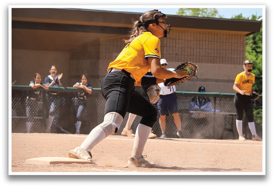A girl in a yellow shirt is catching a ball. Description generated by AI