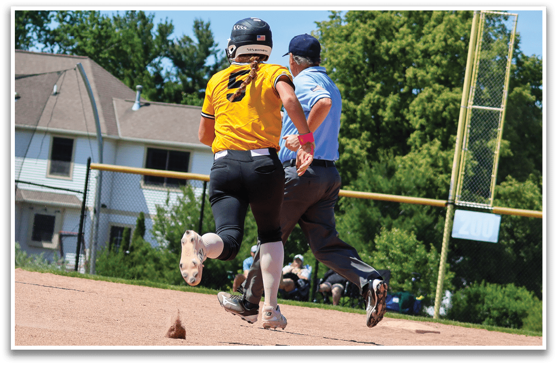 A baseball player running to a base. Description generated by AI
