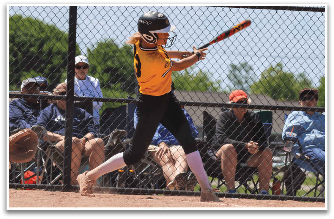 A baseball player in a yellow shirt and black pants is swinging a bat. Description generated by AI